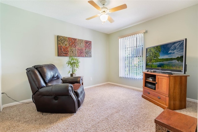 living area featuring carpet flooring, baseboards, and ceiling fan