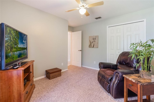 living area featuring a ceiling fan, visible vents, carpet floors, and baseboards