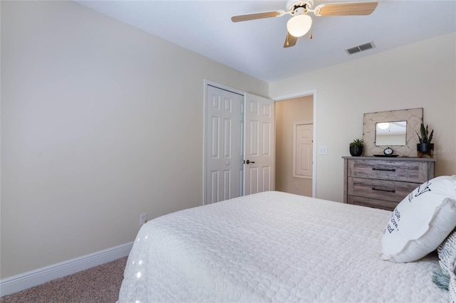 carpeted bedroom with a closet, visible vents, ceiling fan, and baseboards