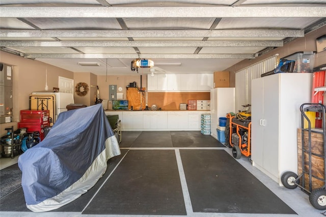 garage with electric panel and a garage door opener