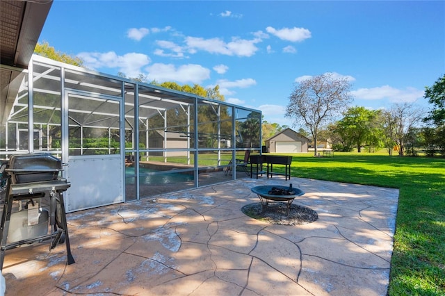 view of patio / terrace featuring an outbuilding, a grill, a lanai, and an outdoor fire pit