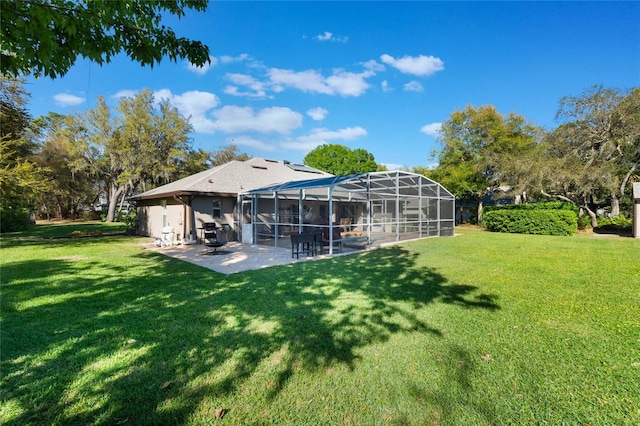 view of yard with glass enclosure and a patio area