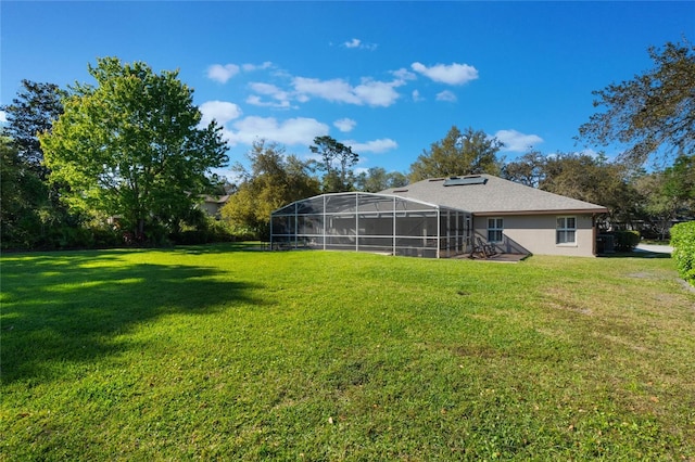 view of yard with glass enclosure