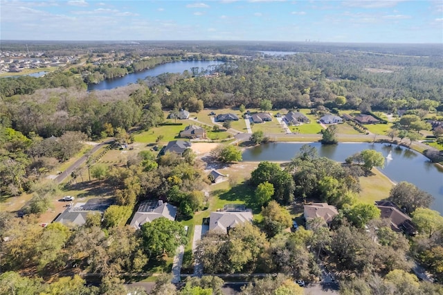 bird's eye view featuring a view of trees, a water view, and a residential view