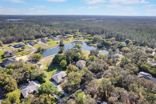 aerial view featuring a residential view, a forest view, and a water view