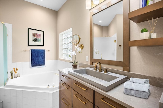 bathroom with vanity, walk in shower, and a bath