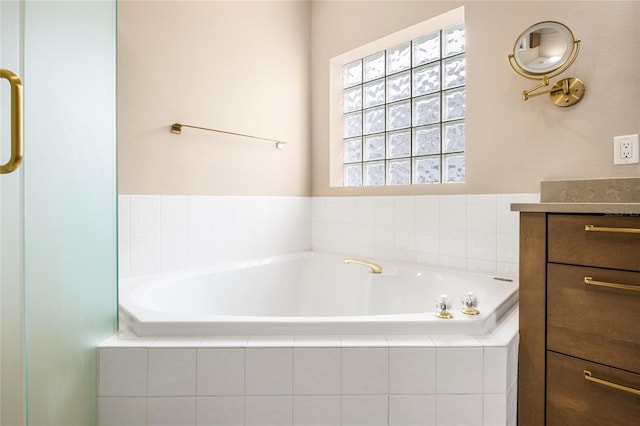 full bathroom with a bath and vanity