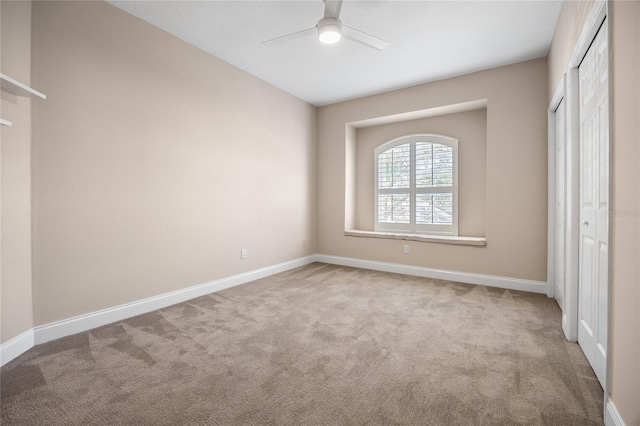 unfurnished bedroom featuring ceiling fan, a closet, carpet flooring, and baseboards