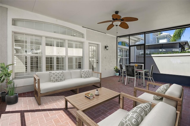 sunroom / solarium with a ceiling fan