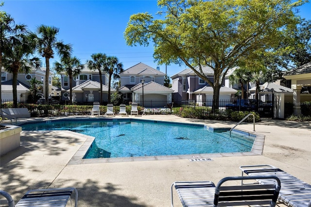 pool featuring a residential view, fence, and a patio