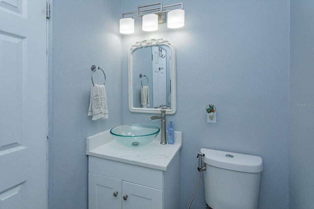 bathroom with toilet and vanity