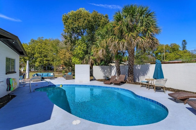 view of swimming pool featuring an outdoor living space, a fenced in pool, a patio, and fence