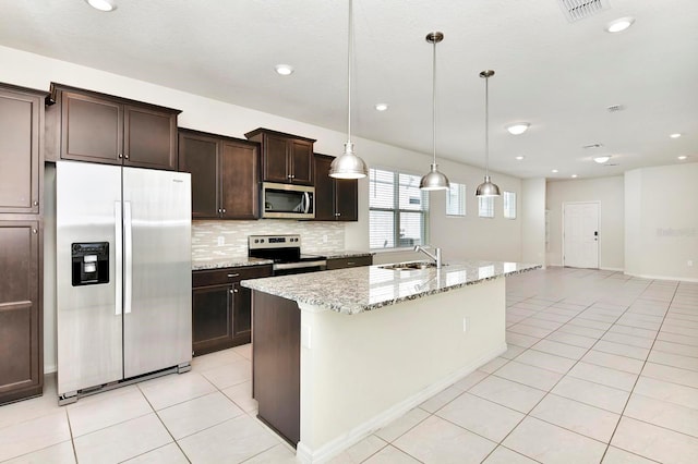 kitchen with light tile patterned flooring, stainless steel appliances, visible vents, dark brown cabinets, and backsplash