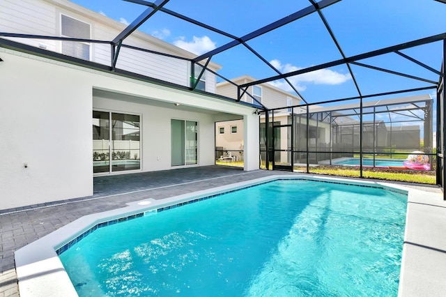 outdoor pool with a lanai and a patio