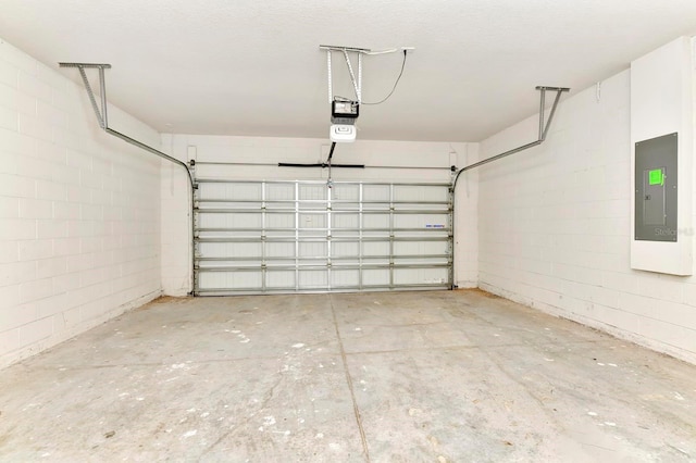 garage featuring concrete block wall and electric panel