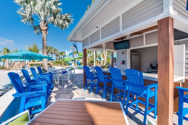 deck featuring a patio area, outdoor dry bar, and outdoor dining space