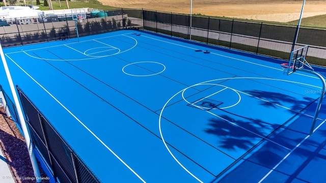 view of basketball court with community basketball court and fence