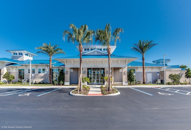 view of building exterior with uncovered parking