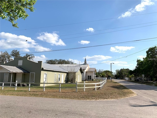 view of front of house featuring a fenced front yard and metal roof