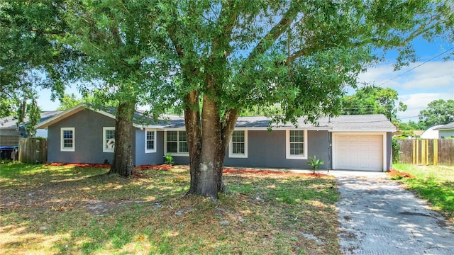 single story home with a garage, fence, driveway, and stucco siding