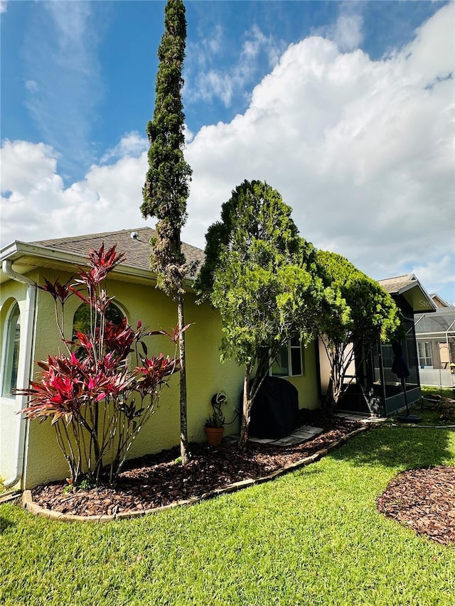 view of home's exterior with a yard and stucco siding