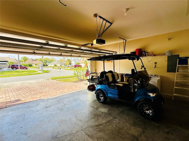 garage featuring electric panel and a garage door opener