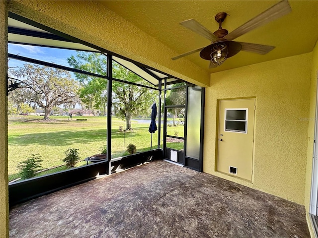 unfurnished sunroom with plenty of natural light and ceiling fan