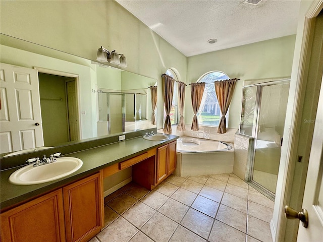 bathroom with a bath, a stall shower, double vanity, and a sink