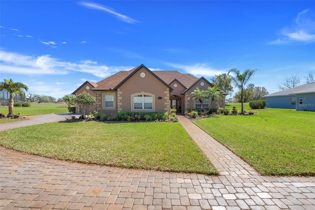 view of front of property featuring a front lawn and stucco siding