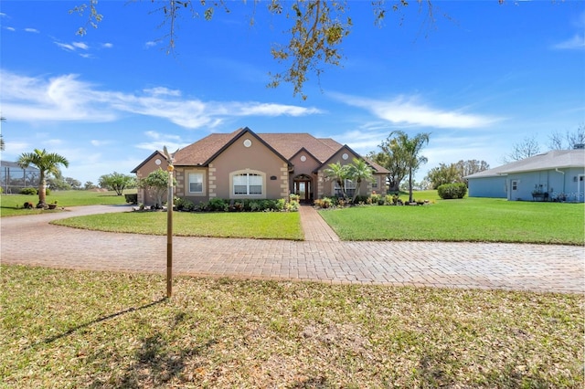 view of front facade featuring a front lawn and stucco siding