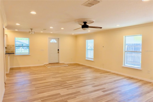 interior space featuring visible vents, baseboards, and light wood finished floors