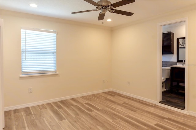 spare room featuring light wood-type flooring, ornamental molding, recessed lighting, baseboards, and ceiling fan