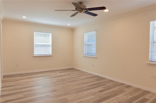 unfurnished room with crown molding, light wood-style flooring, baseboards, and ceiling fan