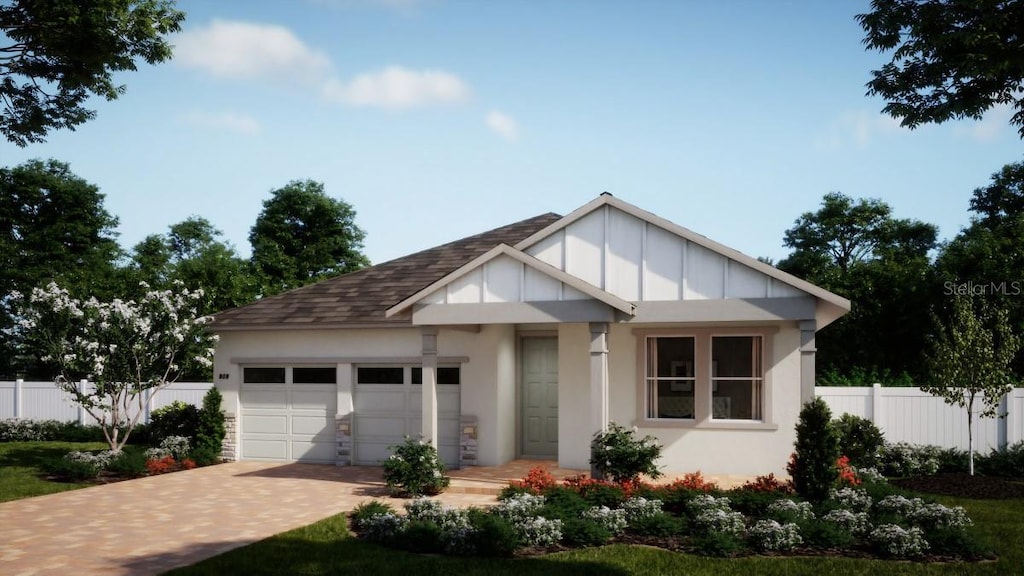 view of front facade featuring decorative driveway, stucco siding, an attached garage, board and batten siding, and fence