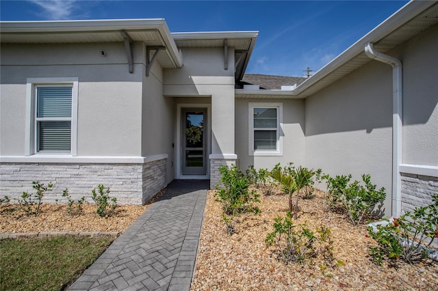 2720 Bancroft Blvd, Orlando, FL 32833 - property entrance with stone siding, stucco siding, and roof with shingles