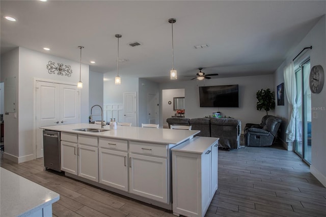 2720 Bancroft Blvd, Orlando, FL 32833 - kitchen with a sink, a center island with sink, wood finish floors, visible vents, and white cabinets