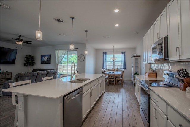 2720 Bancroft Blvd, Orlando, FL 32833 - kitchen with wood finished floors, a sink, appliances with stainless steel finishes, and visible vents