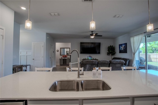 2720 Bancroft Blvd, Orlando, FL 32833 - kitchen featuring a ceiling fan, a sink, light stone counters, hanging light fixtures, and open floor plan