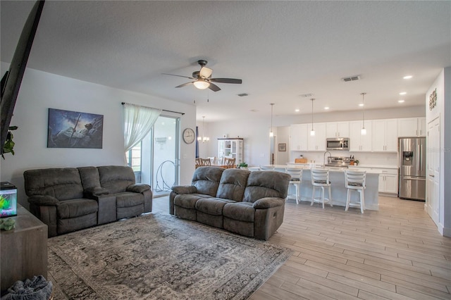 2720 Bancroft Blvd, Orlando, FL 32833 - living room featuring light wood finished floors, a textured ceiling, visible vents, ceiling fan, and recessed lighting
