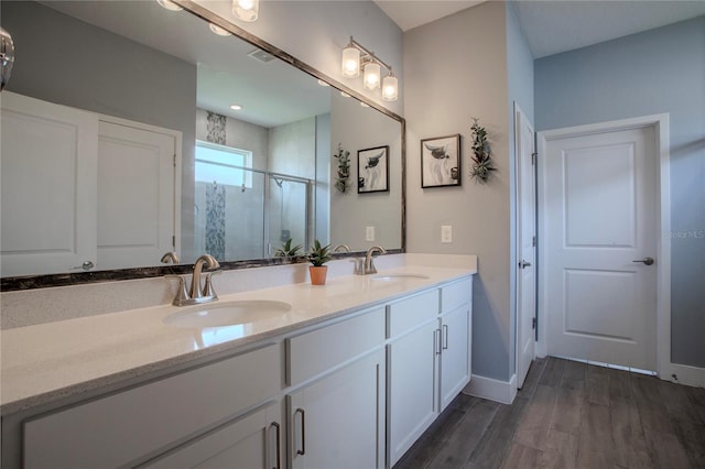 2720 Bancroft Blvd, Orlando, FL 32833 - full bathroom featuring double vanity, a sink, a stall shower, and wood finished floors