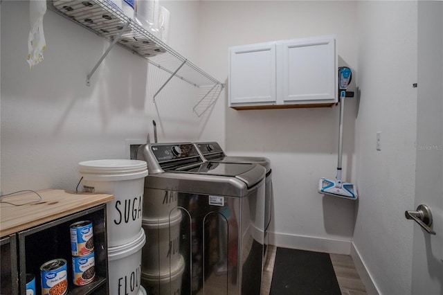 2720 Bancroft Blvd, Orlando, FL 32833 - laundry room with baseboards, wood finished floors, washing machine and clothes dryer, and cabinet space