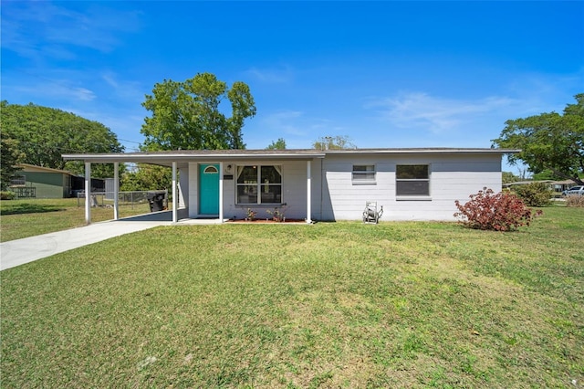 ranch-style home with an attached carport, concrete driveway, and a front lawn