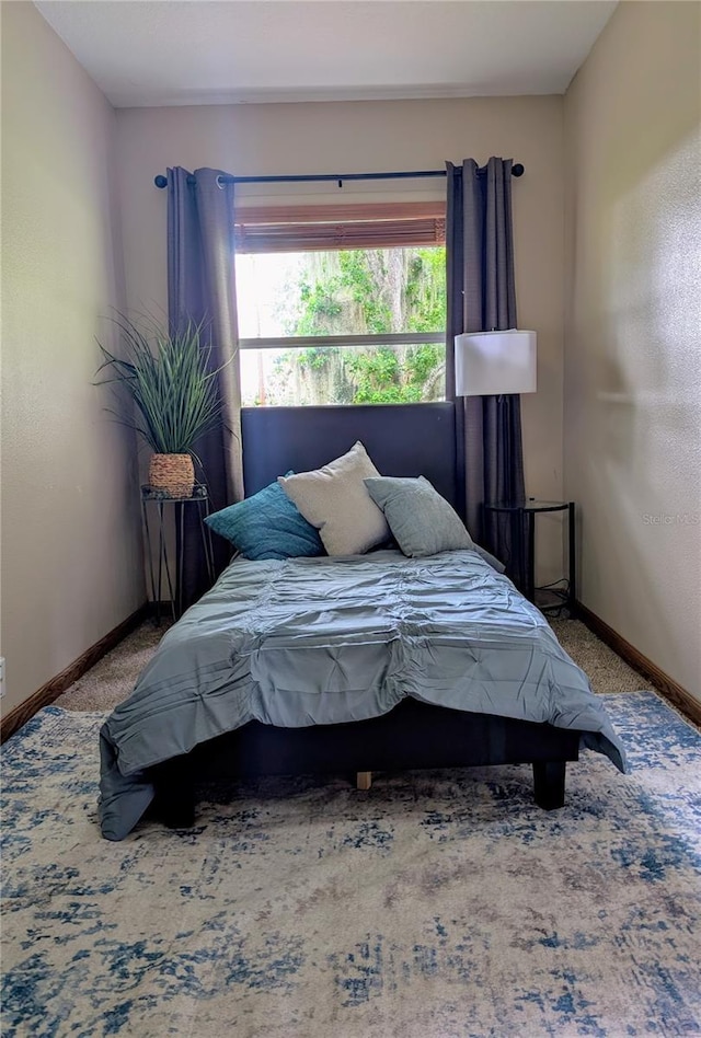 bedroom with carpet flooring and baseboards