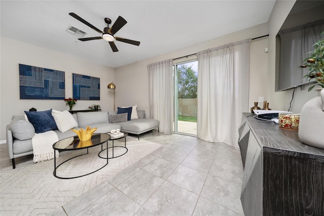 living room featuring a ceiling fan, visible vents, and light tile patterned floors