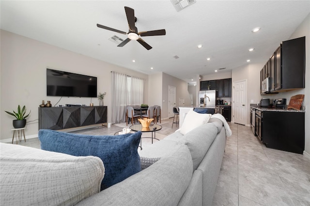 living area with a ceiling fan, recessed lighting, visible vents, and light tile patterned floors