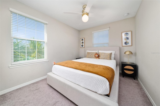 carpeted bedroom featuring ceiling fan and baseboards