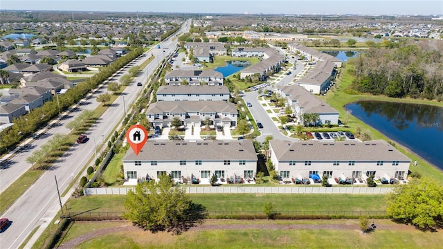 drone / aerial view with a water view and a residential view