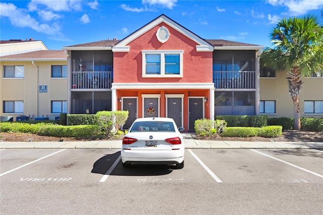 view of building exterior with uncovered parking