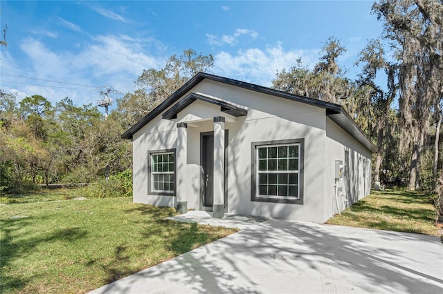 view of front of property with a front yard and stucco siding