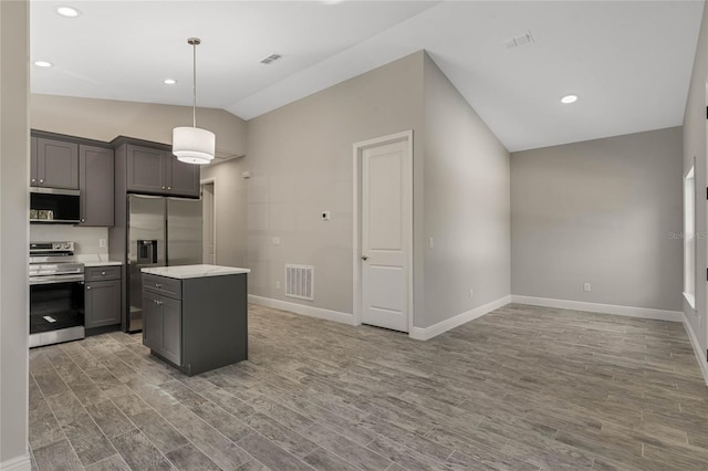 kitchen featuring gray cabinets, light countertops, visible vents, light wood-style flooring, and appliances with stainless steel finishes